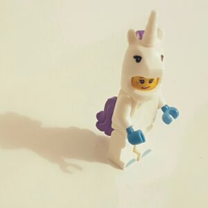 a toy figure of a person in a unicorn garment. Digital Marketing, Strategy, Paid Media. Ana Isabel Moura.